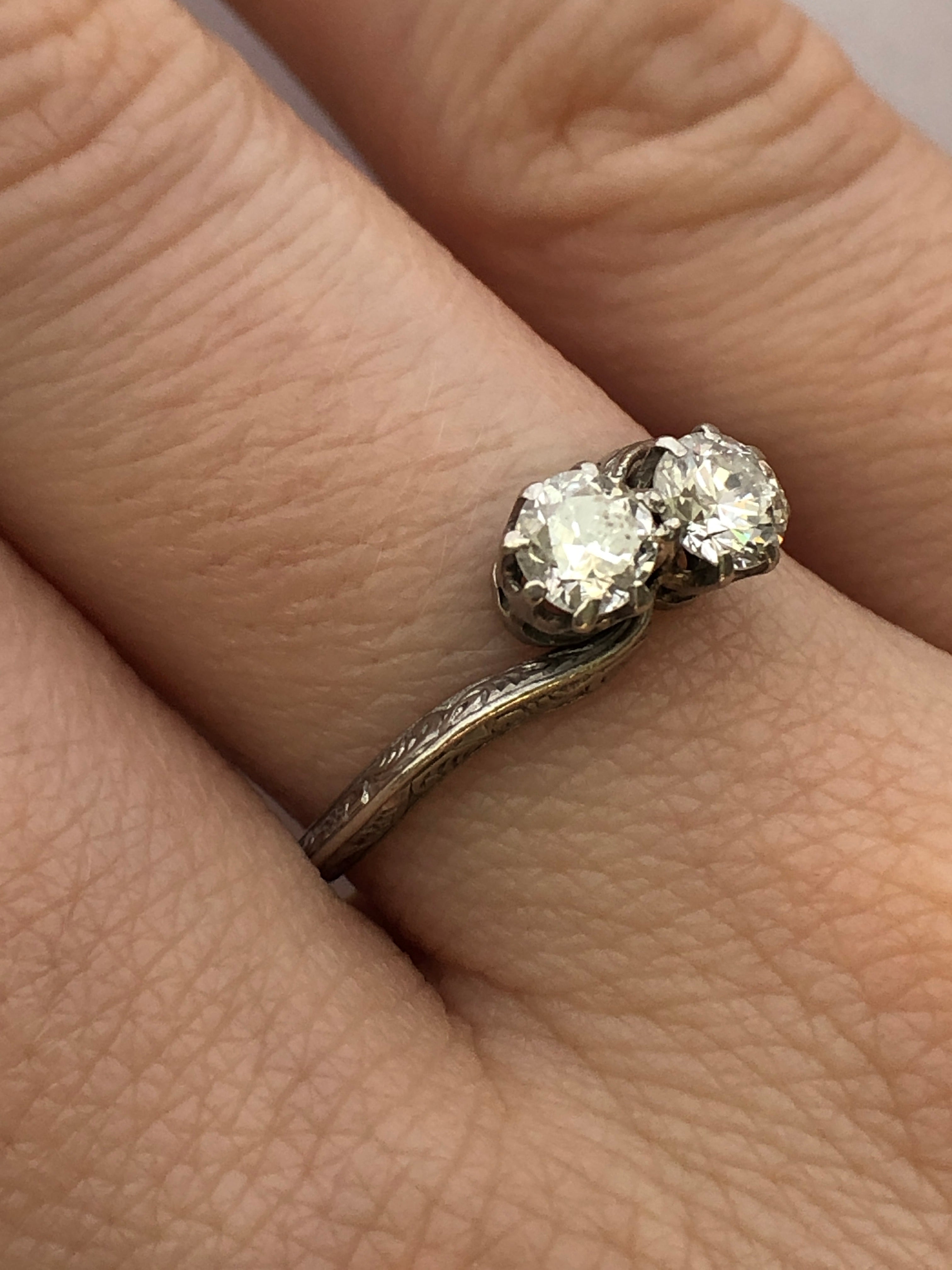 An antique platinum and diamond two stone twist ring