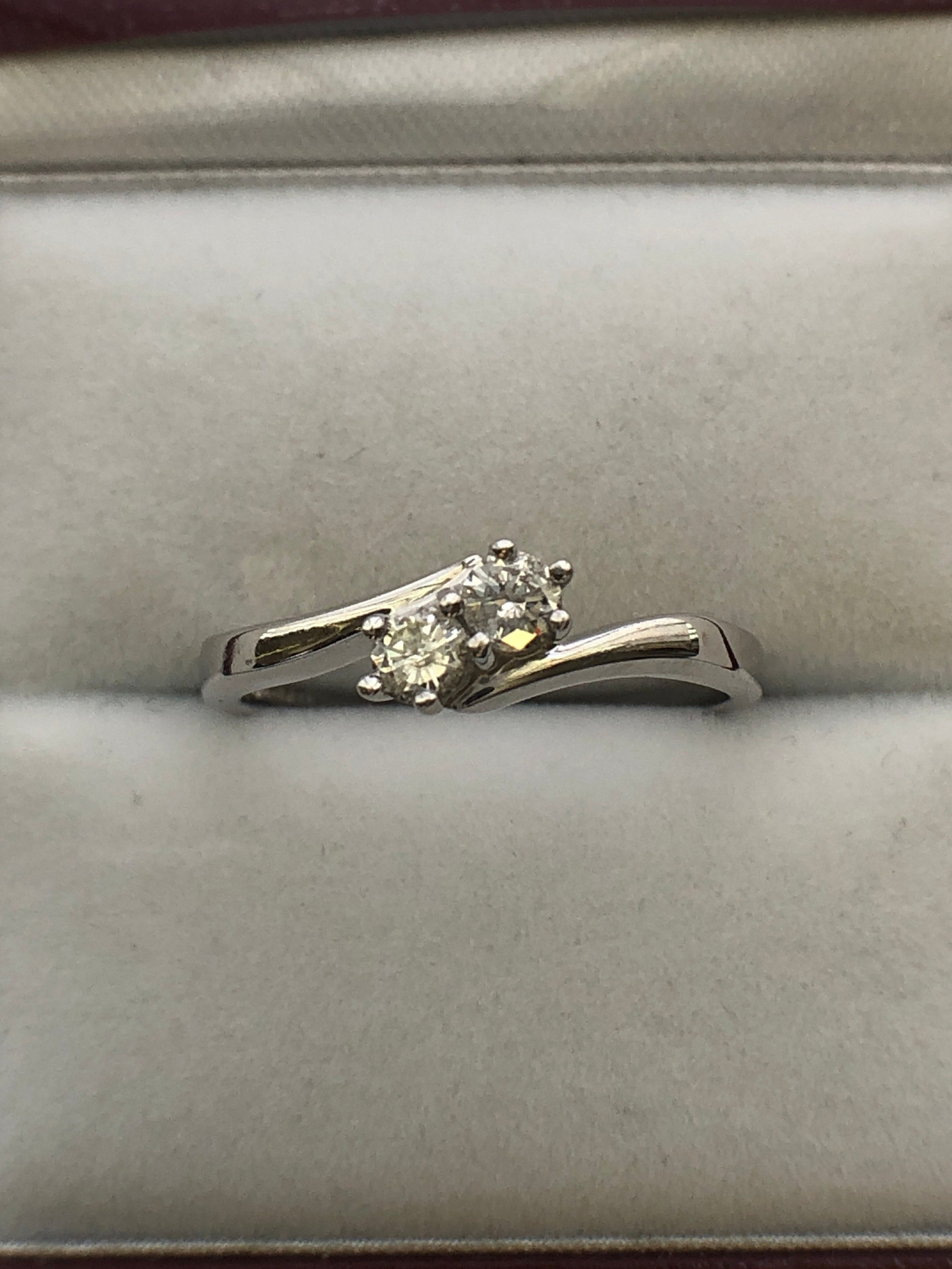 An 18ct white gold diamond two stone twist ring