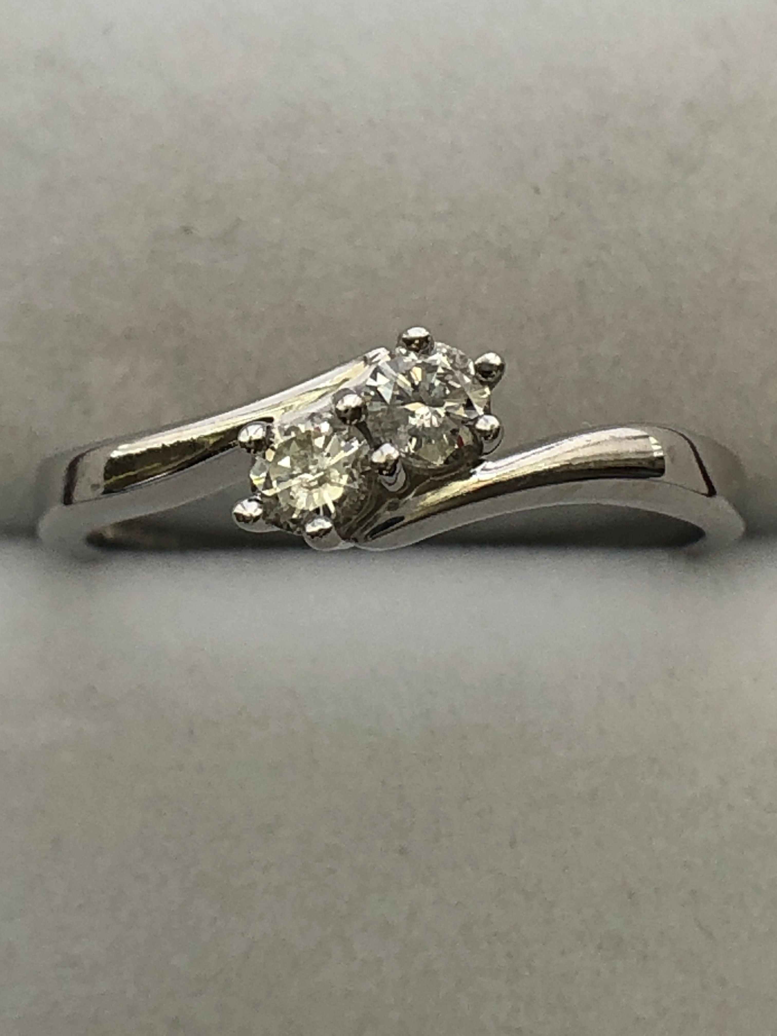 An 18ct white gold diamond two stone twist ring