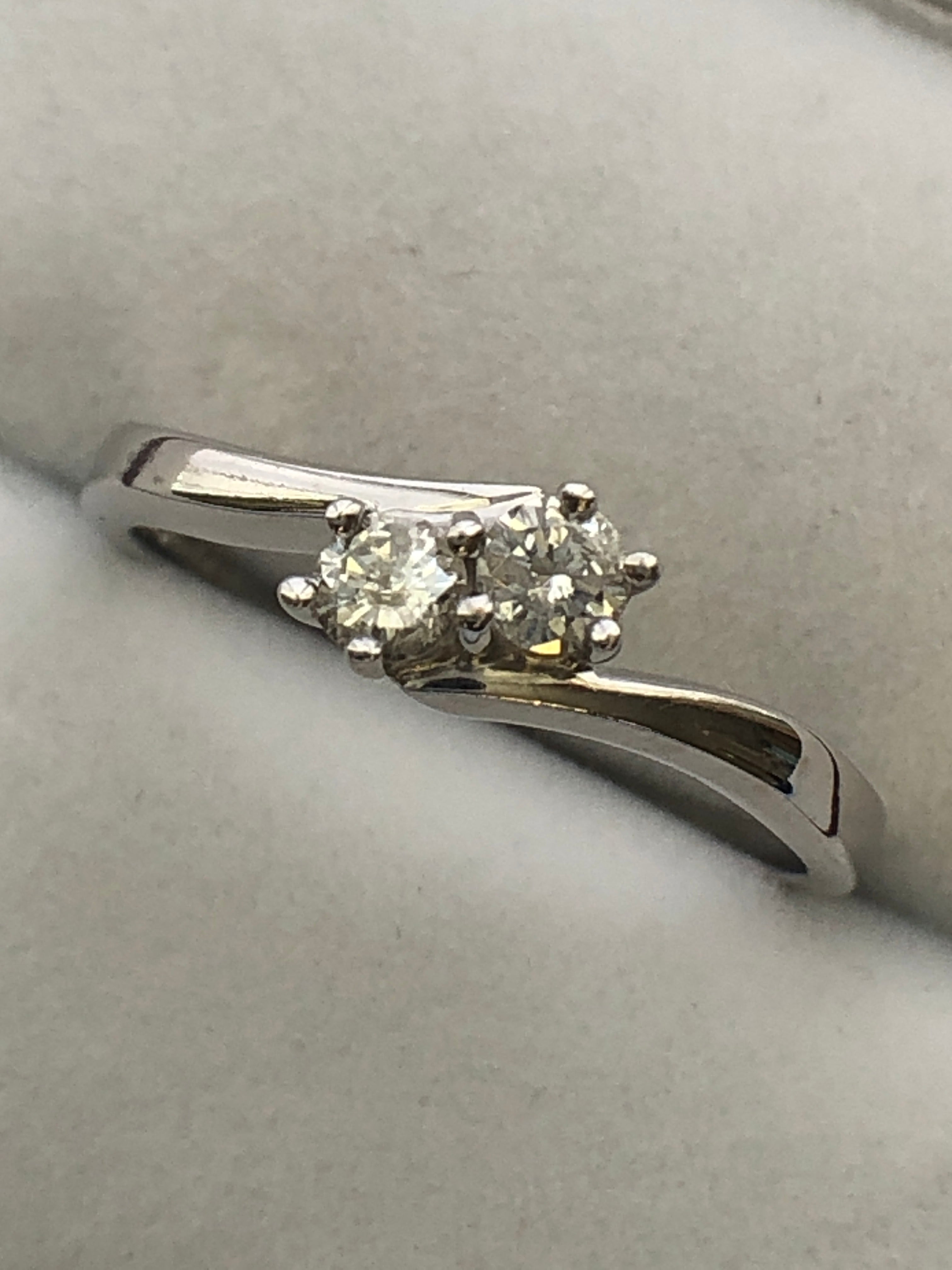 An 18ct white gold diamond two stone twist ring