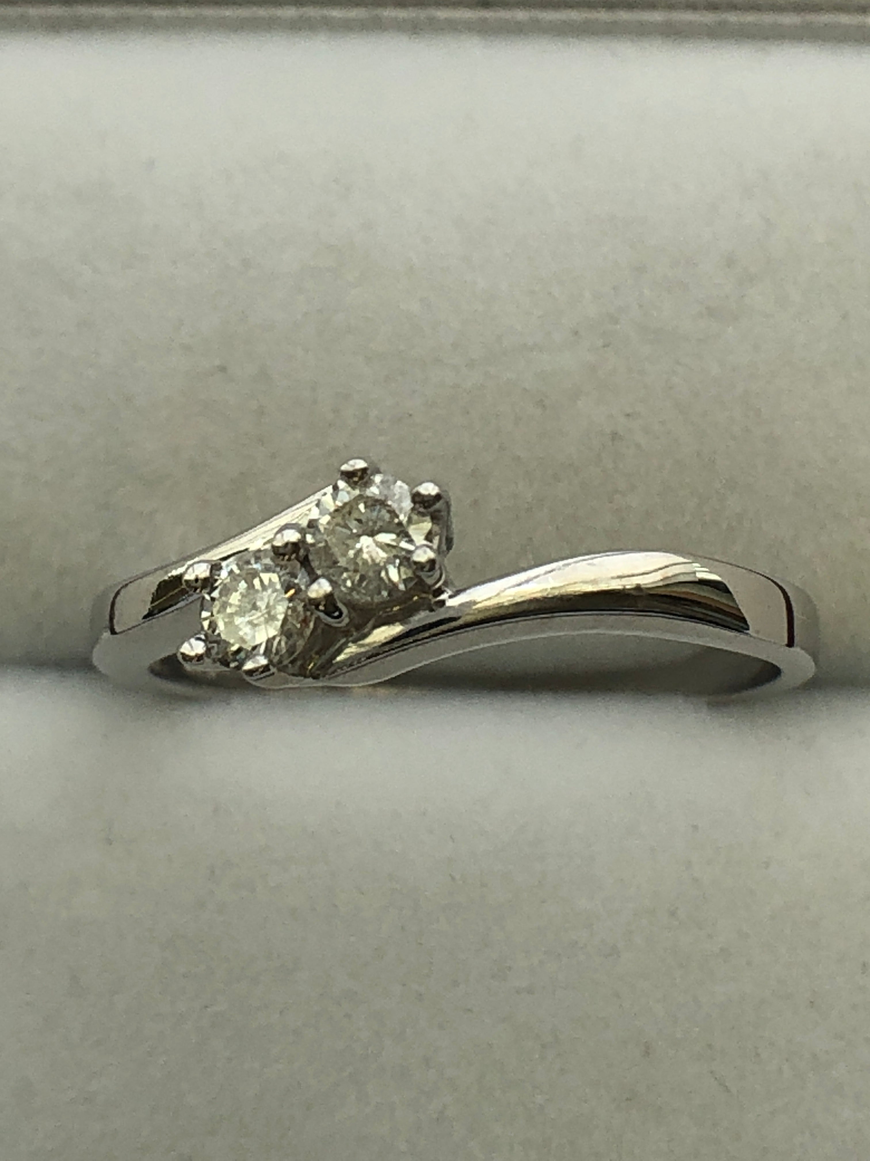 An 18ct white gold diamond two stone twist ring
