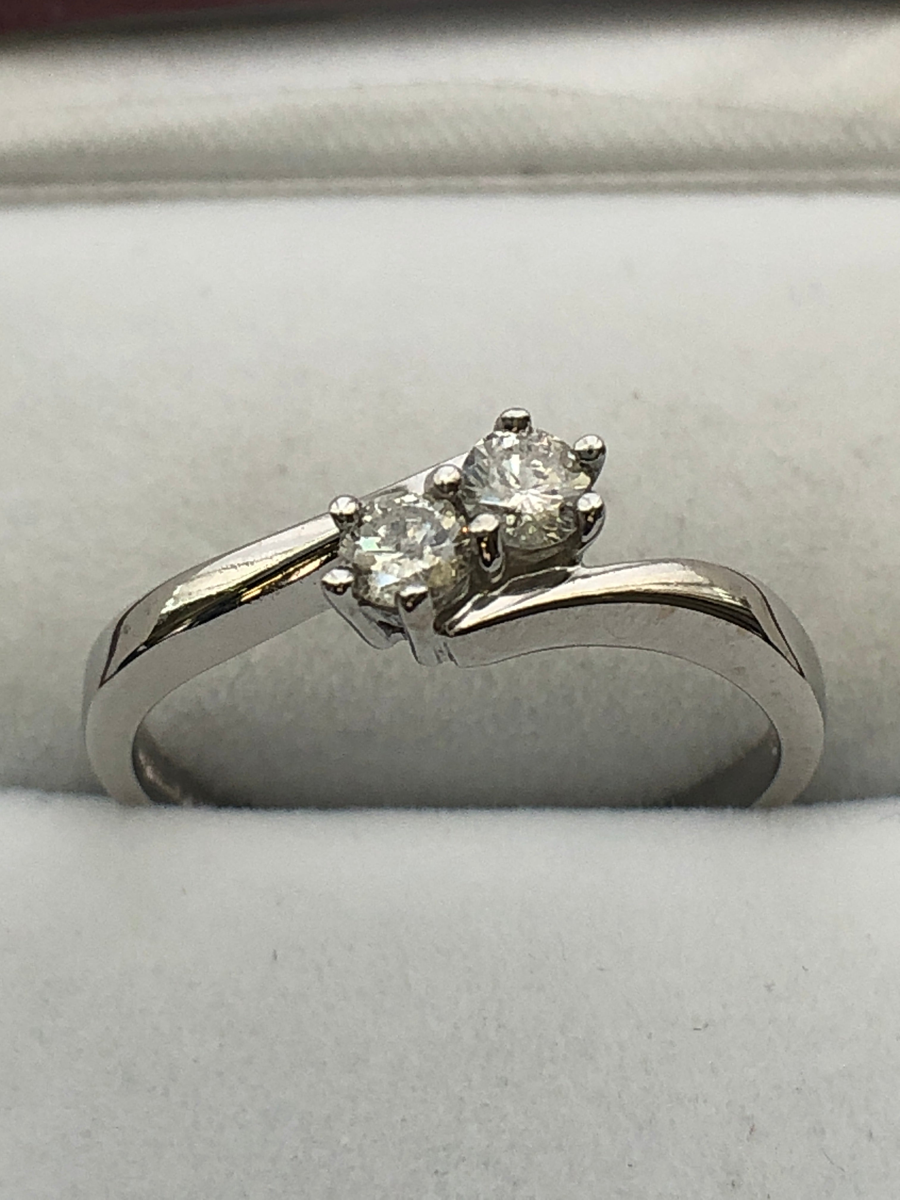An 18ct white gold diamond two stone twist ring