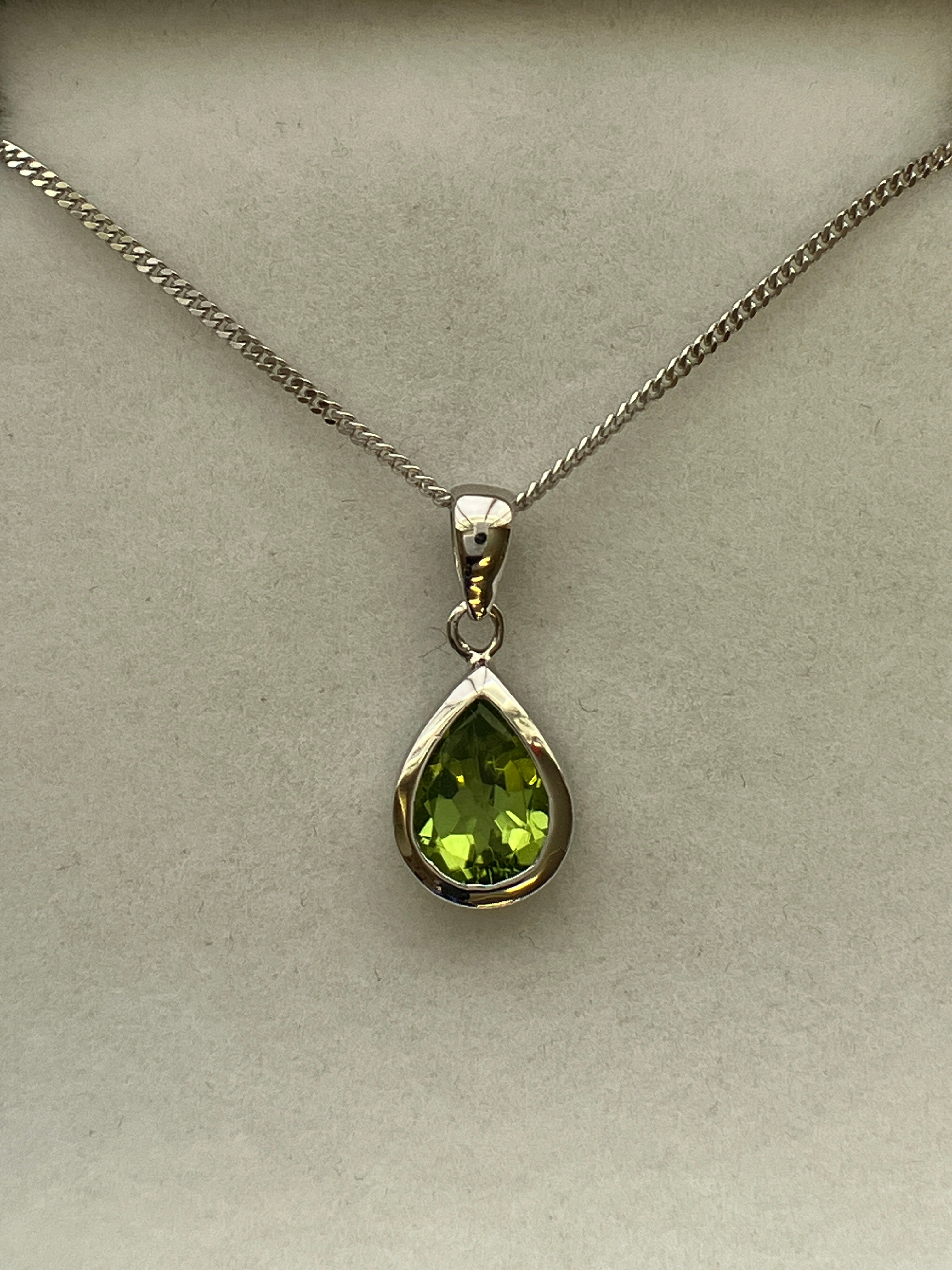 A 9ct white gold peridot pendant