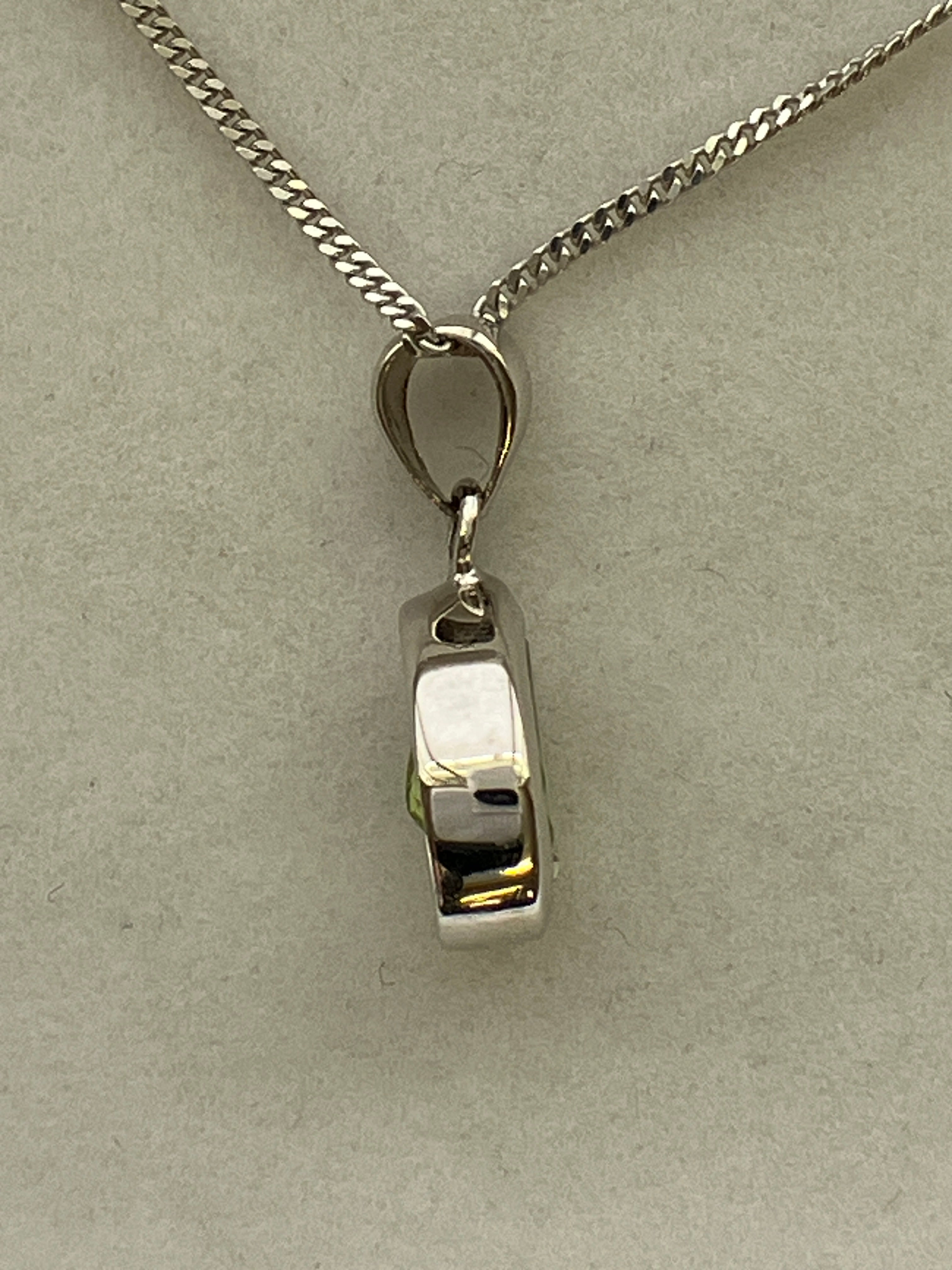 A 9ct white gold peridot pendant