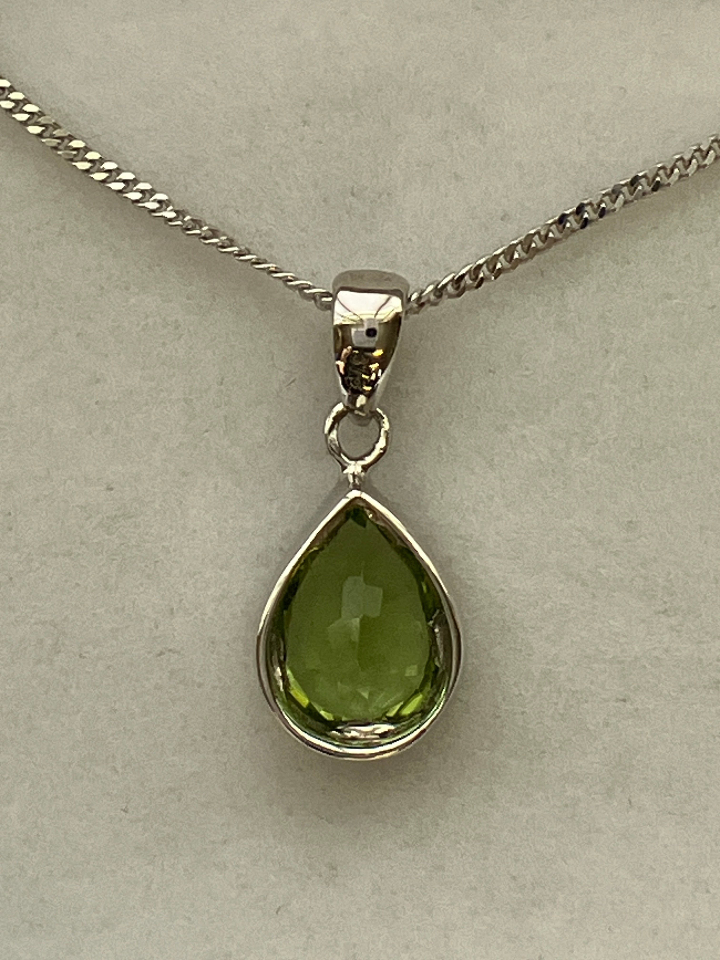 A 9ct white gold peridot pendant
