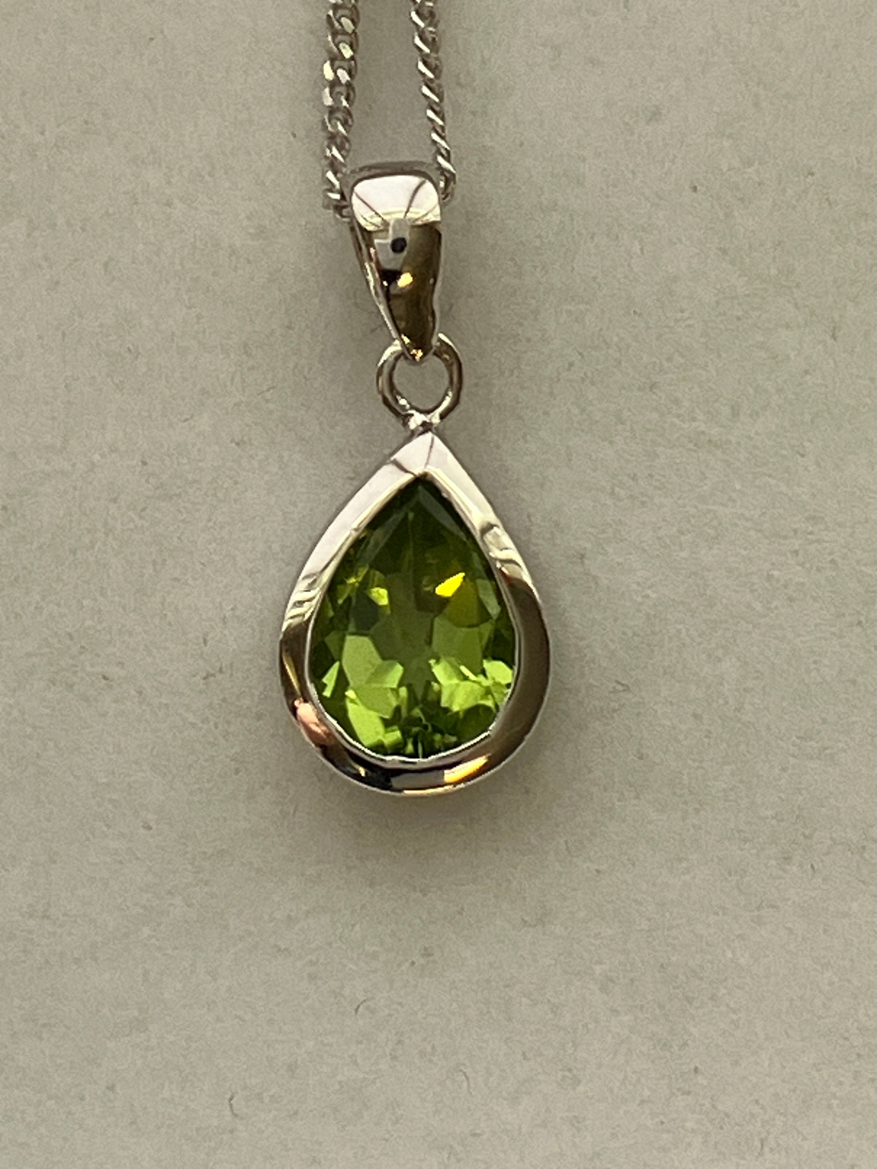 A 9ct white gold peridot pendant