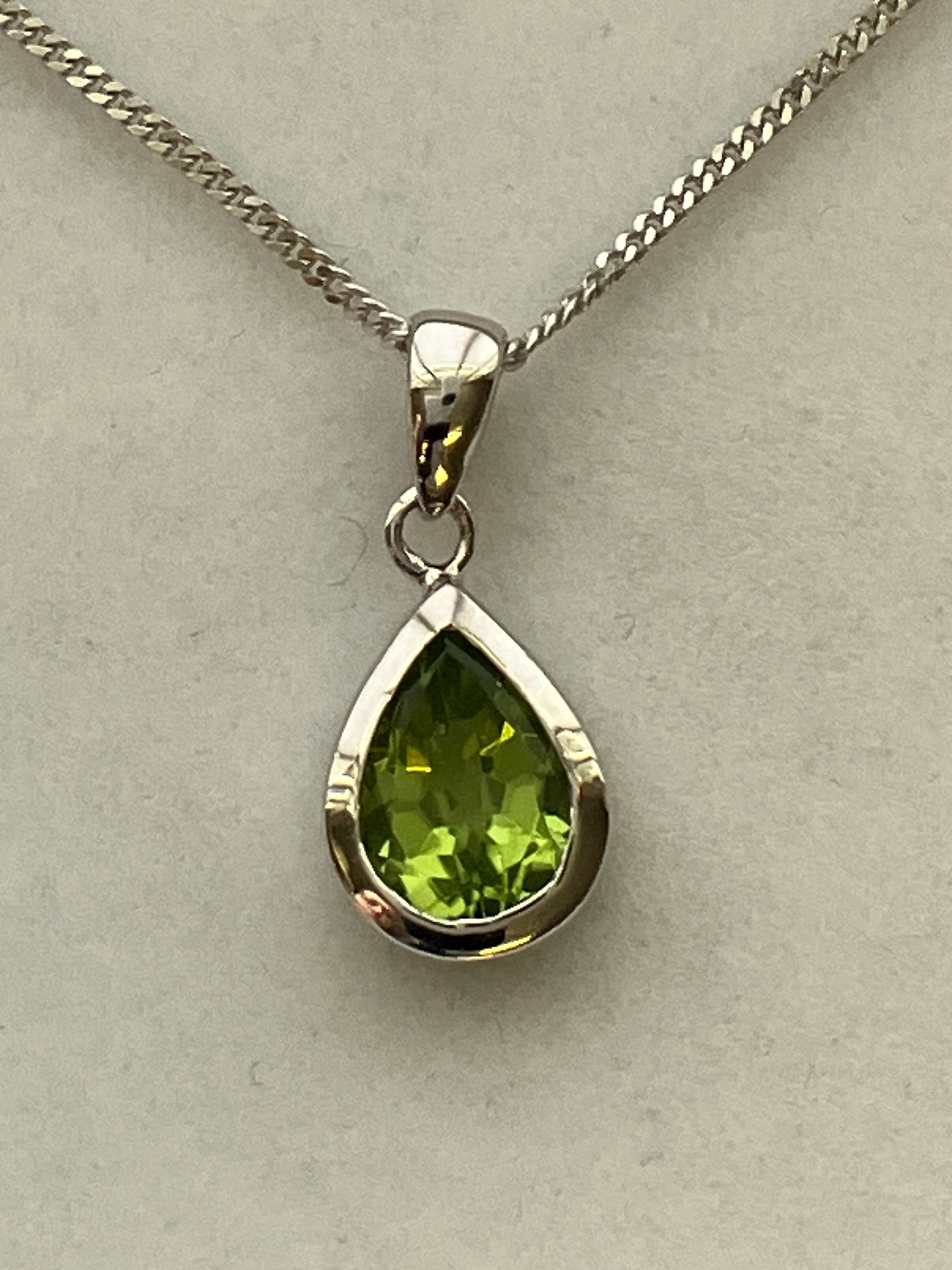 A 9ct white gold peridot pendant