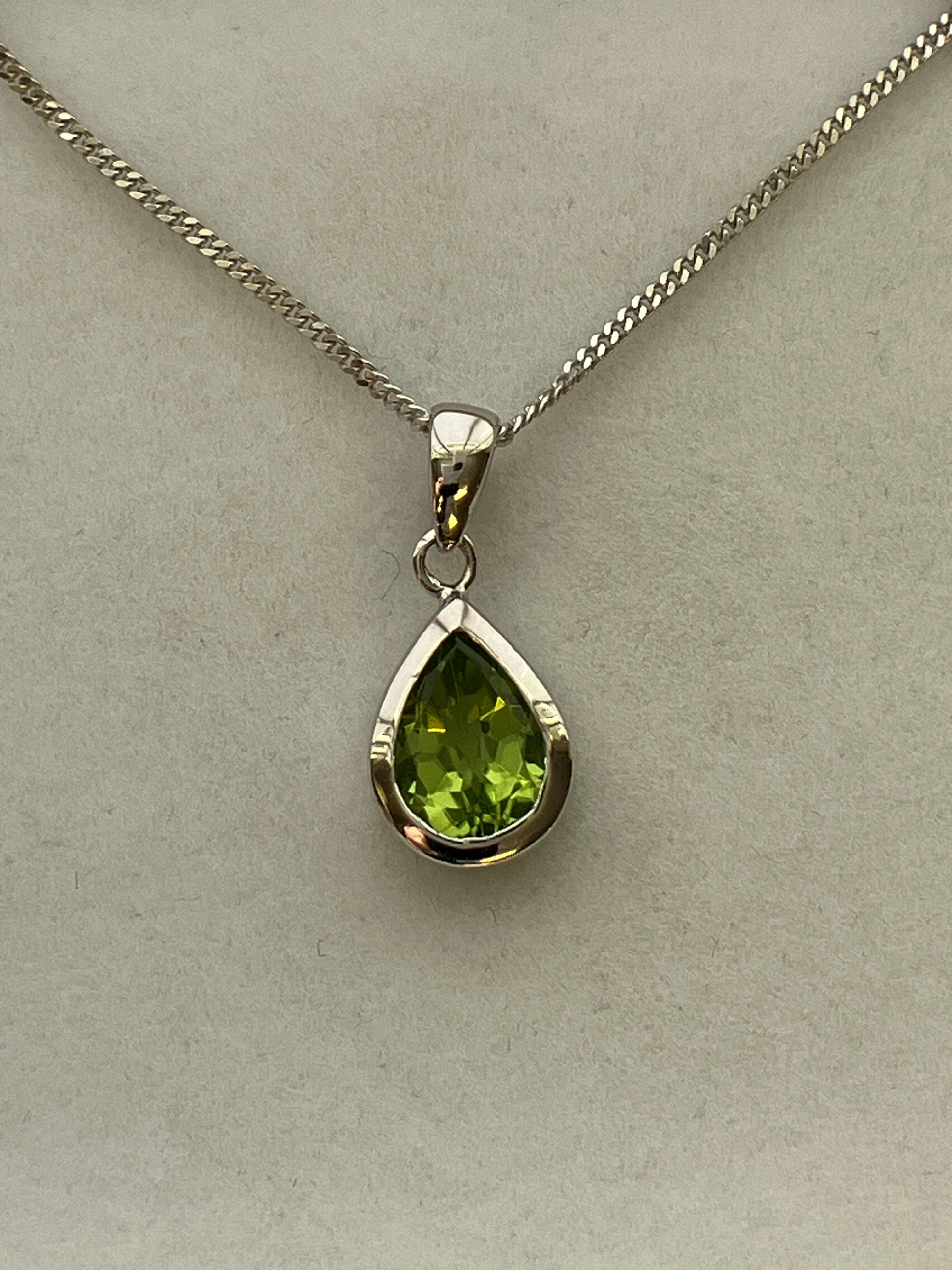 A 9ct white gold peridot pendant