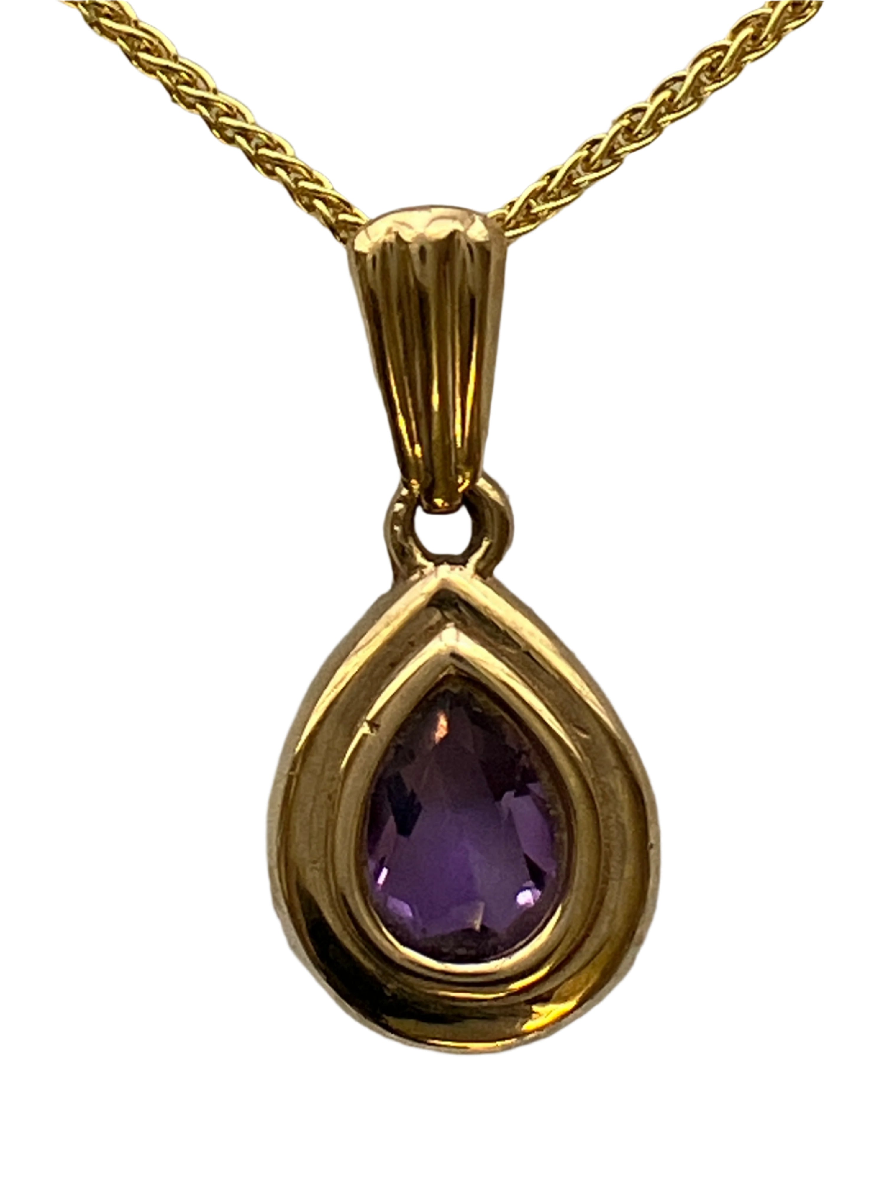 A 9ct gold amethyst pendant on a 9ct gold chain
