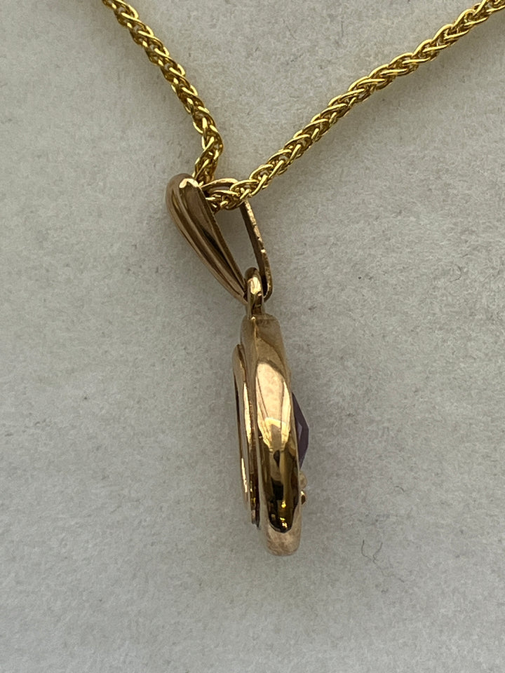 A 9ct gold amethyst pendant on a 9ct gold chain