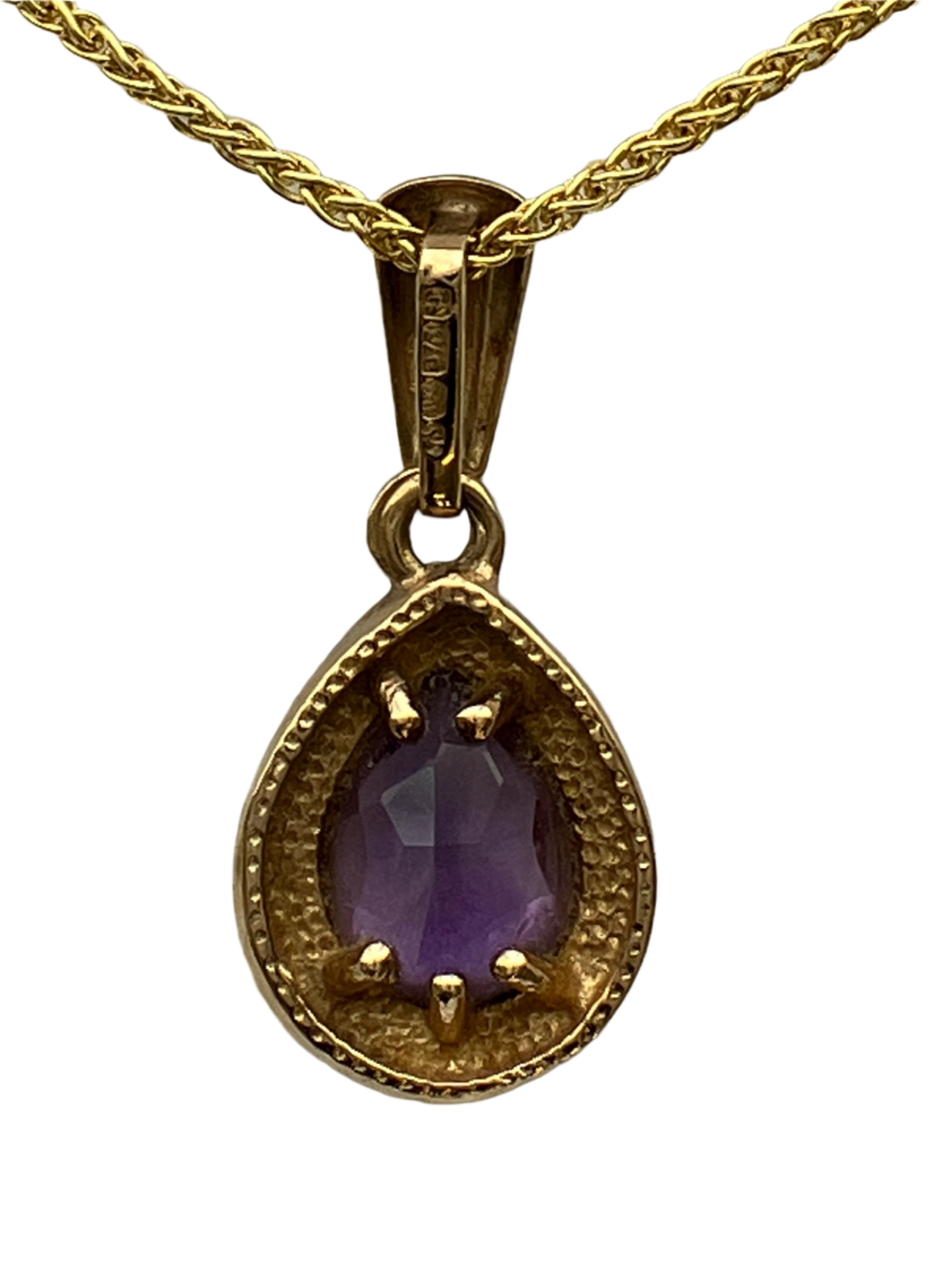 A 9ct gold amethyst pendant on a 9ct gold chain