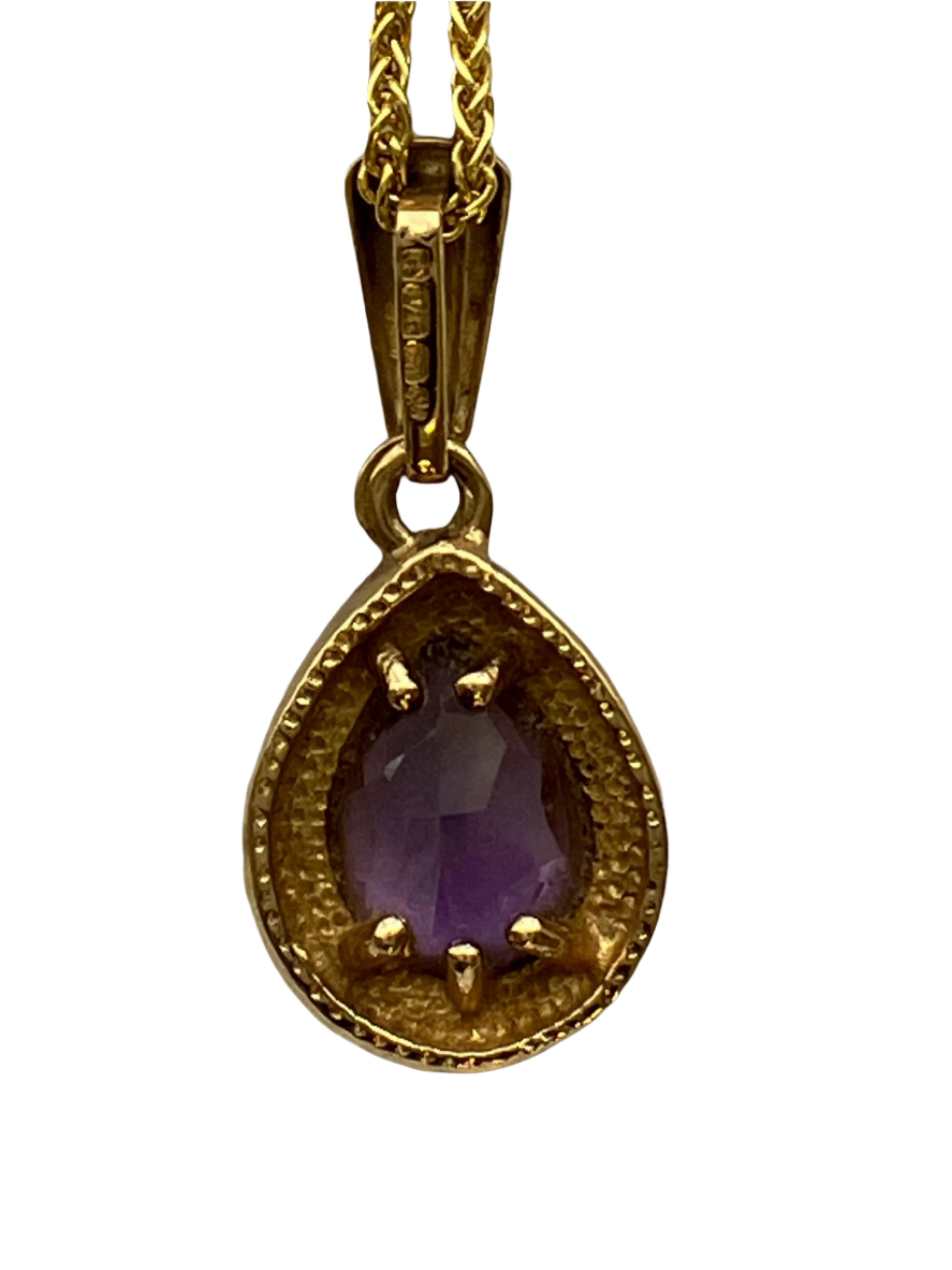 A 9ct gold amethyst pendant on a 9ct gold chain
